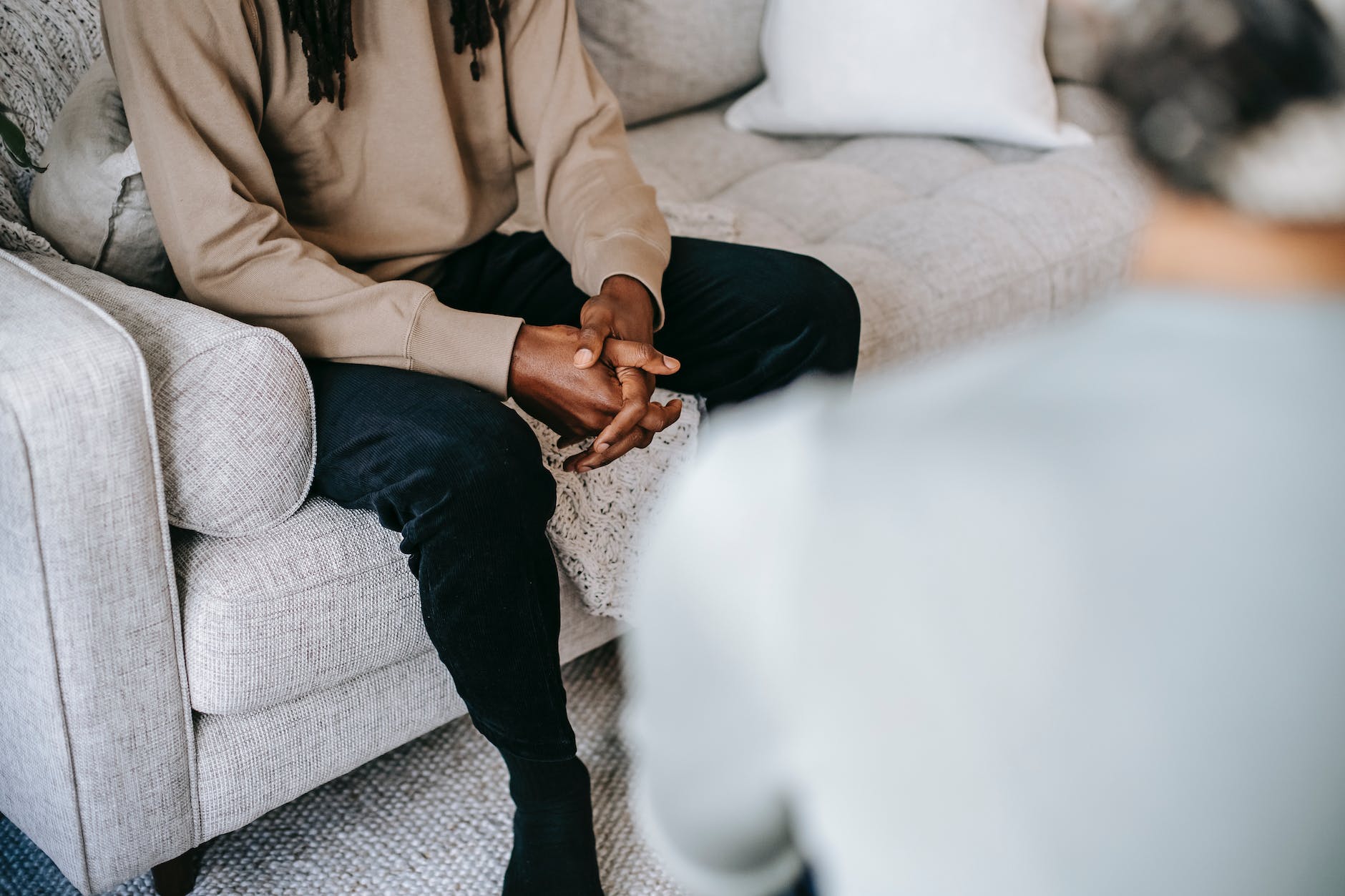 crop ethnic man having conversation with psychologist